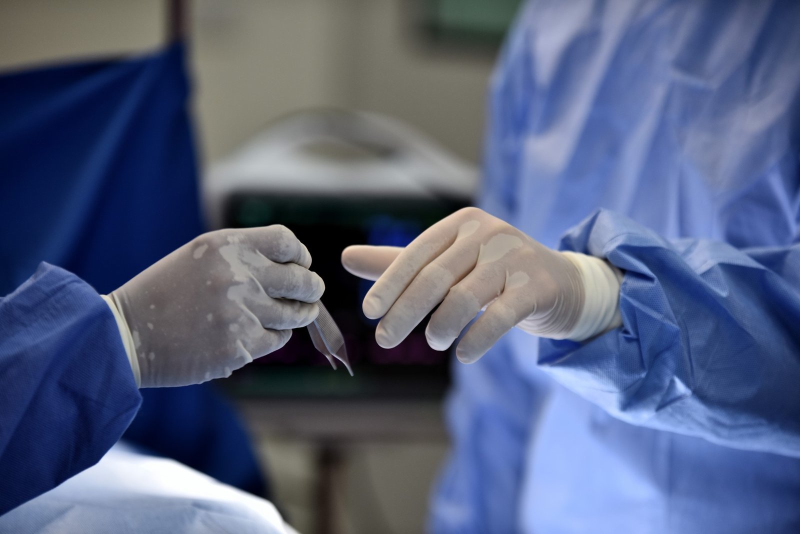 doctors-holding-equipment-operating-room
